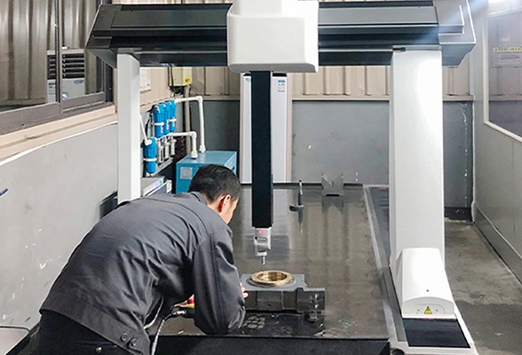 Quality control technician using a coordinate measuring machine (CMM) to inspect mechanical parts