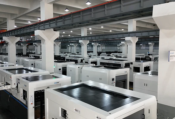 Fully automatic die-cutting machines lined up in a modern, spacious manufacturing facility
