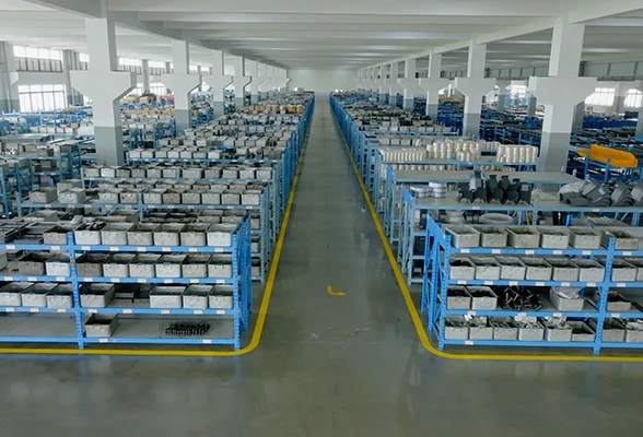 Spacious and organized industrial warehouse with blue metal shelving and neatly arranged parts storage