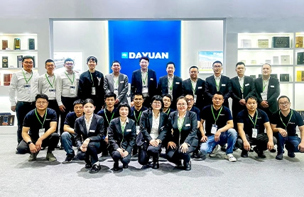 Dayuan team group photo at exhibition booth with product samples