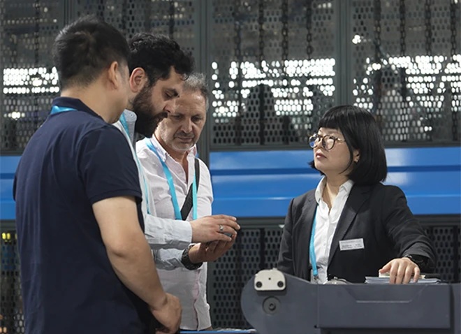 sales representative explaining industrial equipment to overseas customers