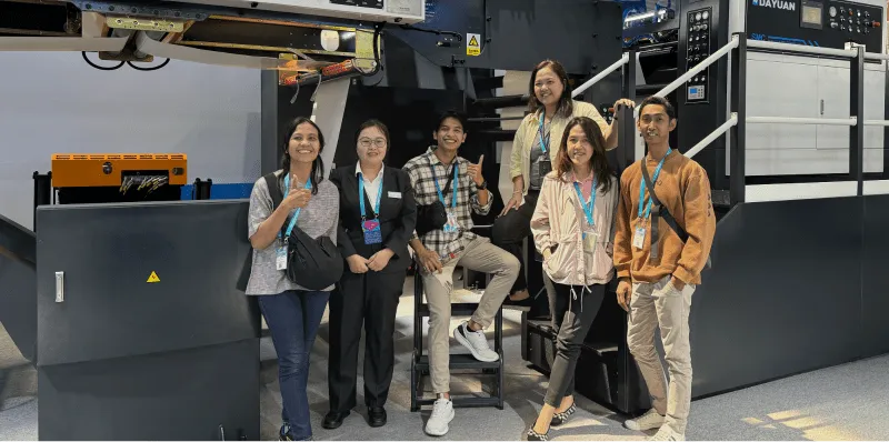 International clients with Dayuan staff at printing machine exhibition booth