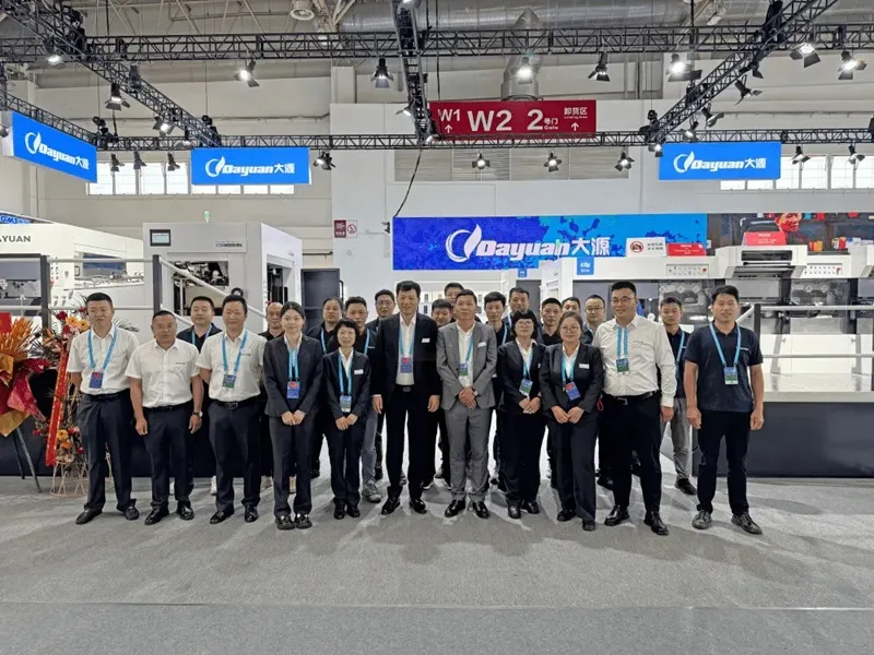 Dayuan Machinery team photo at China Print exhibition booth with staff and equipment