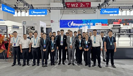 /Dayuan Machinery team photo at China Print exhibition booth with staff and equipment